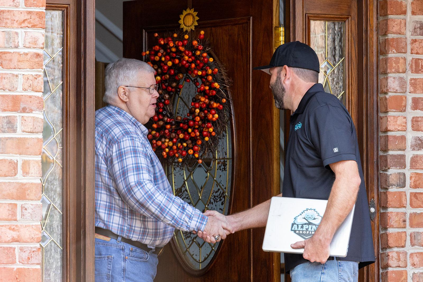 Alpine Roofing team member meeting a homeowner at their front door in Williamsburg, VA